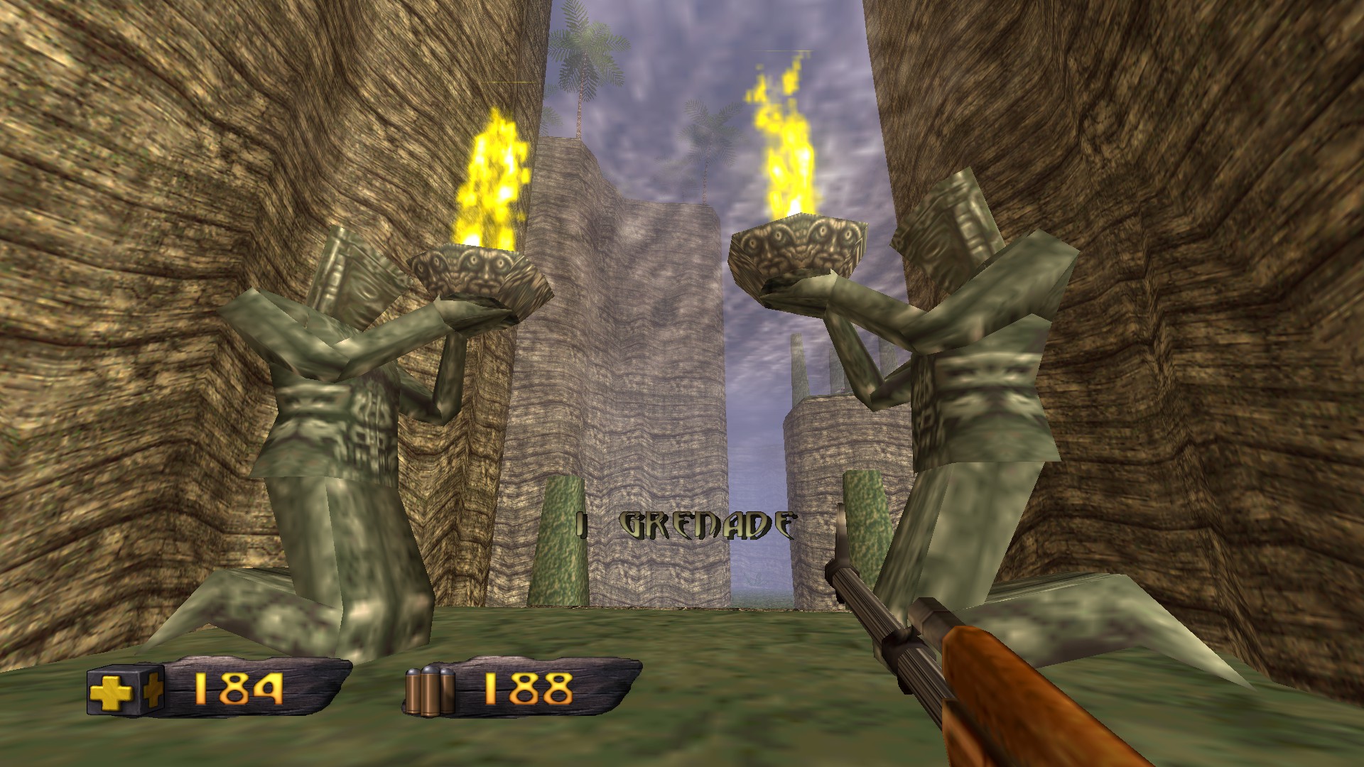 In-game screenshot of a level with two large fire holding statues on either side.